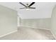Large bedroom with ceiling fan, neutral carpet, and slanted ceilings at 2041 Jefferson Ave, Gastonia, NC 28056