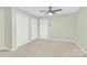 Large bedroom featuring neutral carpet, a ceiling fan, and white doors at 2041 Jefferson Ave, Gastonia, NC 28056