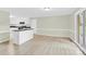 Open dining area with wood-look floors and adjacent kitchen featuring an island at 2041 Jefferson Ave, Gastonia, NC 28056