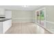 Dining area featuring modern vinyl plank flooring and double doors leading to the backyard at 2041 Jefferson Ave, Gastonia, NC 28056