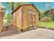 Charming wooden exterior shed for storage or workshop, surrounded by lush greenery and foliage at 2041 Jefferson Ave, Gastonia, NC 28056