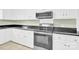 Modern kitchen with updated stainless steel appliances, white cabinets, and dark countertops at 2041 Jefferson Ave, Gastonia, NC 28056