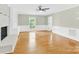 Inviting living room with hardwood floors, fireplace, and a ceiling fan, perfect for relaxing at 2041 Jefferson Ave, Gastonia, NC 28056