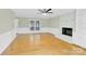 Spacious living room with hardwood floors, a white brick fireplace, and natural light at 2041 Jefferson Ave, Gastonia, NC 28056