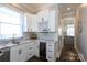 Stylish home bar with white cabinets, marble countertops, and a wine cooler, perfect for entertaining at 2526 Fort St, Charlotte, NC 28205