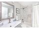 Modern bathroom featuring gray and white marble-like tiles, a stylish shower, and a vanity with sink at 2526 Fort St, Charlotte, NC 28205