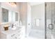 Well-lit bathroom features white marble floors, a vanity with a framed mirror and a glass-enclosed shower at 2526 Fort St, Charlotte, NC 28205
