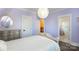 This bedroom features a light purple color, wood floors, and a beautifully decorated bed frame and light fixture at 2526 Fort St, Charlotte, NC 28205