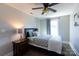 A well-lit bedroom with ceiling fan, dark wood floors, and a comfortable bed at 2526 Fort St, Charlotte, NC 28205