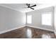 Bright bedroom features hardwood floors, a ceiling fan, neutral walls and two bright windows at 2526 Fort St, Charlotte, NC 28205