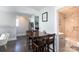 A dining area with a dark wooden table, visible staircase, and a peek into a bathroom and kitchen at 2526 Fort St, Charlotte, NC 28205