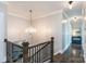 Upstairs hallway showcases a crystal chandelier and provides a view of the home's tasteful decor and bright atmosphere at 2526 Fort St, Charlotte, NC 28205