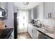 This kitchen features gray cabinets, a window, stainless steel appliances, and marble countertops at 2526 Fort St, Charlotte, NC 28205
