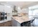 Bright kitchen with an island, modern appliances, granite countertops, and sleek white cabinets at 2526 Fort St, Charlotte, NC 28205