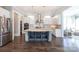 Bright eat-in kitchen with a large center island, stainless hood vent, modern appliances and pendant lighting at 2526 Fort St, Charlotte, NC 28205