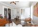 Bright living room with a piano, hardwood floors, and a view to the second floor staircase at 2526 Fort St, Charlotte, NC 28205
