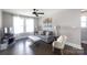 Cozy living room featuring a comfortable gray sofa, decorative lamps, and a ceiling fan at 2526 Fort St, Charlotte, NC 28205