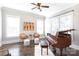 Bright living room with large windows, hardwood floors, a ceiling fan and a grand piano at 2526 Fort St, Charlotte, NC 28205