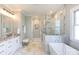 Luxurious bathroom features a soaking tub, glass-enclosed shower, granite countertop and tile floors at 2526 Fort St, Charlotte, NC 28205