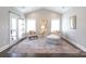 Bright sitting room boasts a comfortable chaise lounge, elegant chair, and natural light with access to a private balcony at 2526 Fort St, Charlotte, NC 28205