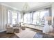 Inviting sunroom filled with natural light, comfortable seating, neutral colors and a built-in window seat at 2526 Fort St, Charlotte, NC 28205