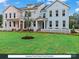 Beautiful front elevation of colorful townhomes with well-kept lawns and charming white picket fences at 274 Gilead Rd, Huntersville, NC 28078