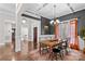 Formal dining room boasts natural light, hardwood floors, neutral paint, and a decorative chandelier at 279 Farm Estates Dr, Rockwell, NC 28138