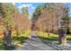 Long paved driveway flanked by brick pillars and mature trees, leading to the home at 279 Farm Estates Dr, Rockwell, NC 28138