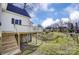 View of the backyard with a house, deck and stairs leading to the lawn at 305 S Clay St, Gastonia, NC 28052