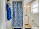A bright bathroom with a blue and white shower curtain and white fixtures at 305 S Clay St, Gastonia, NC 28052