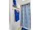 A well-lit bathroom featuring blue towels and a patterned shower curtain at 305 S Clay St, Gastonia, NC 28052