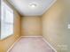 Carpeted bedroom with a window offering natural light, creating a serene and comfortable living space at 305 S Clay St, Gastonia, NC 28052