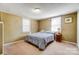 Comfortable bedroom with carpeted floors, natural light, and a relaxing atmosphere at 305 S Clay St, Gastonia, NC 28052