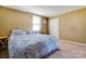 Comfortable bedroom with a large window providing natural light and a decorative blue patterned comforter at 305 S Clay St, Gastonia, NC 28052