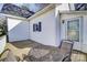 Wooden deck with table and chairs, and a white exterior wall with black window shutters at 305 S Clay St, Gastonia, NC 28052