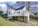 Home exterior with a deck and stairs to the backyard, with the home elevated above the ground at 305 S Clay St, Gastonia, NC 28052