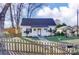 Charming home featuring a manicured lawn, quaint fence, and delightful curb appeal at 305 S Clay St, Gastonia, NC 28052