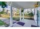 Charming covered front porch with hanging plants and views of the yard and picket fence at 305 S Clay St, Gastonia, NC 28052