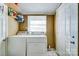 A functional laundry room with a washer, dryer, shelving, and good natural light at 305 S Clay St, Gastonia, NC 28052