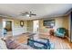 Open living room with hardwood floors and access to bedroom, kitchen, and TV with accent chair at 305 S Clay St, Gastonia, NC 28052