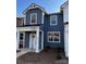 A modern home with a covered porch, white trim, neutral siding, and well-maintained landscaping at 330 Malvern Sw Ave # B, Concord, NC 28025