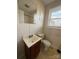 Bathroom with a vanity sink, toilet, and a window offering natural light at 3412 1St Avenue Nw Cir, Hickory, NC 28601