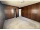 Bedroom boasts wood paneling, neutral carpet, and a spacious closet for ample storage at 3412 1St Avenue Nw Cir, Hickory, NC 28601