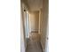 Hallway featuring neutral walls and carpet, with access to several rooms in the home at 3412 1St Avenue Nw Cir, Hickory, NC 28601