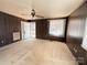 Spacious living room with wood paneled walls, fan, plush carpet, and a front door at 3412 1St Avenue Nw Cir, Hickory, NC 28601