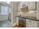 Stylish bar area with wine storage, granite countertop, and custom cabinetry at 411 Belo Ct, Fort Mill, SC 29715