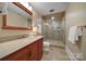 Bathroom featuring a wooden vanity with granite countertop and a tiled walk-in shower at 411 Belo Ct, Fort Mill, SC 29715