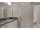 Bathroom features a granite vanity with white cabinets, a mirror, and an entry to additional space at 411 Belo Ct, Fort Mill, SC 29715