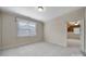 Bedroom featuring neutral walls and carpet, a window, and an attached room at 411 Belo Ct, Fort Mill, SC 29715