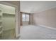 Bright bedroom featuring neutral walls and carpet, a chandelier, and a walk-in closet at 411 Belo Ct, Fort Mill, SC 29715